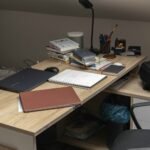 A wooden desk topped with a laptop computer